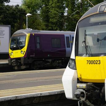 Two modern trains stationed at a railway platform