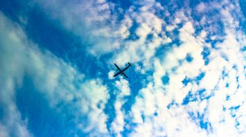 Airplane flying amidst clouds