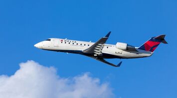 Delta Connection soaring above the clouds