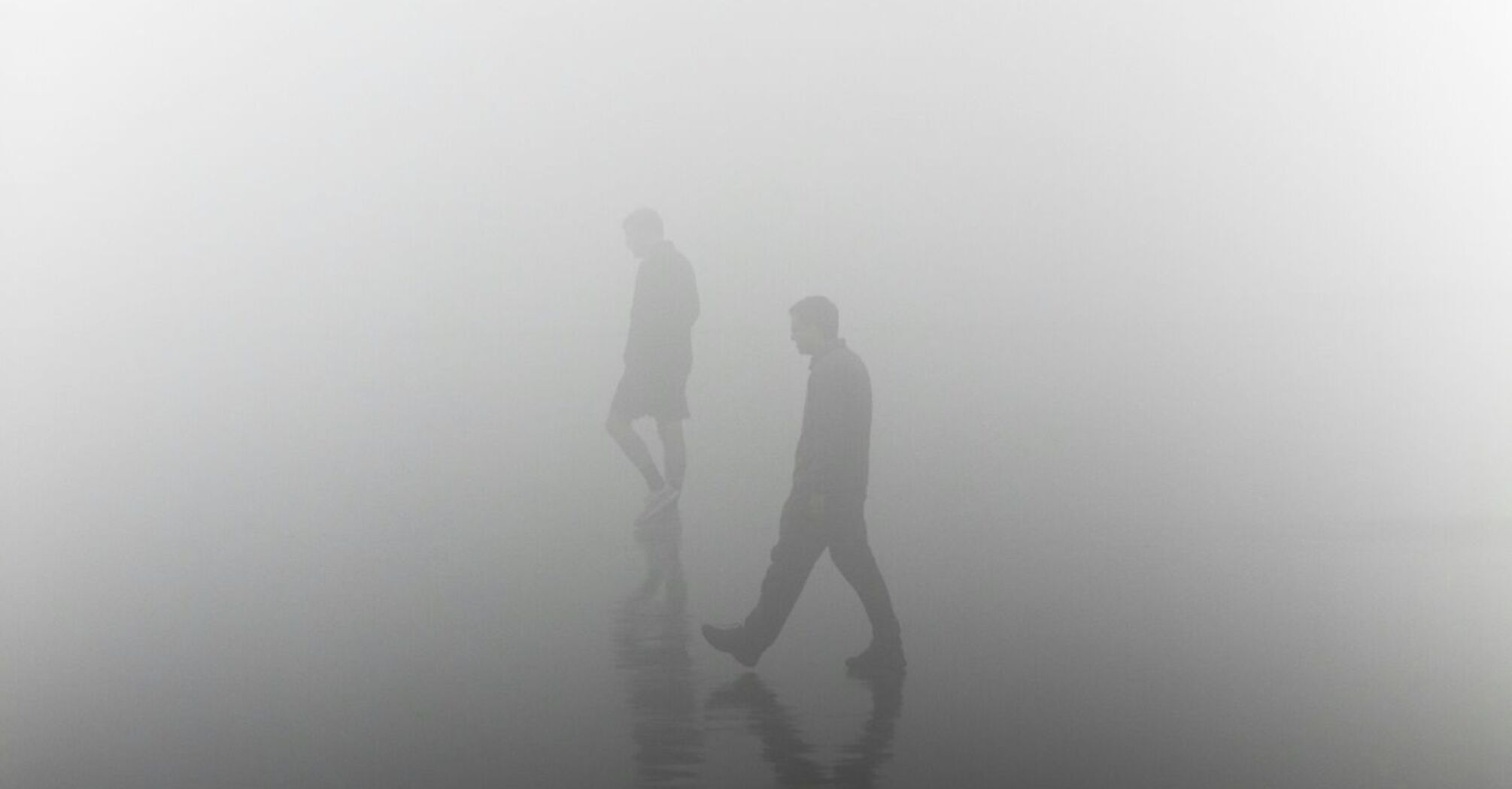 People walking in dense fog