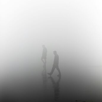 People walking in dense fog