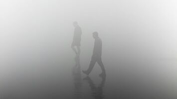People walking in dense fog