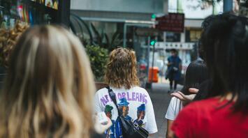 Group of people stands looking at the sights of the city