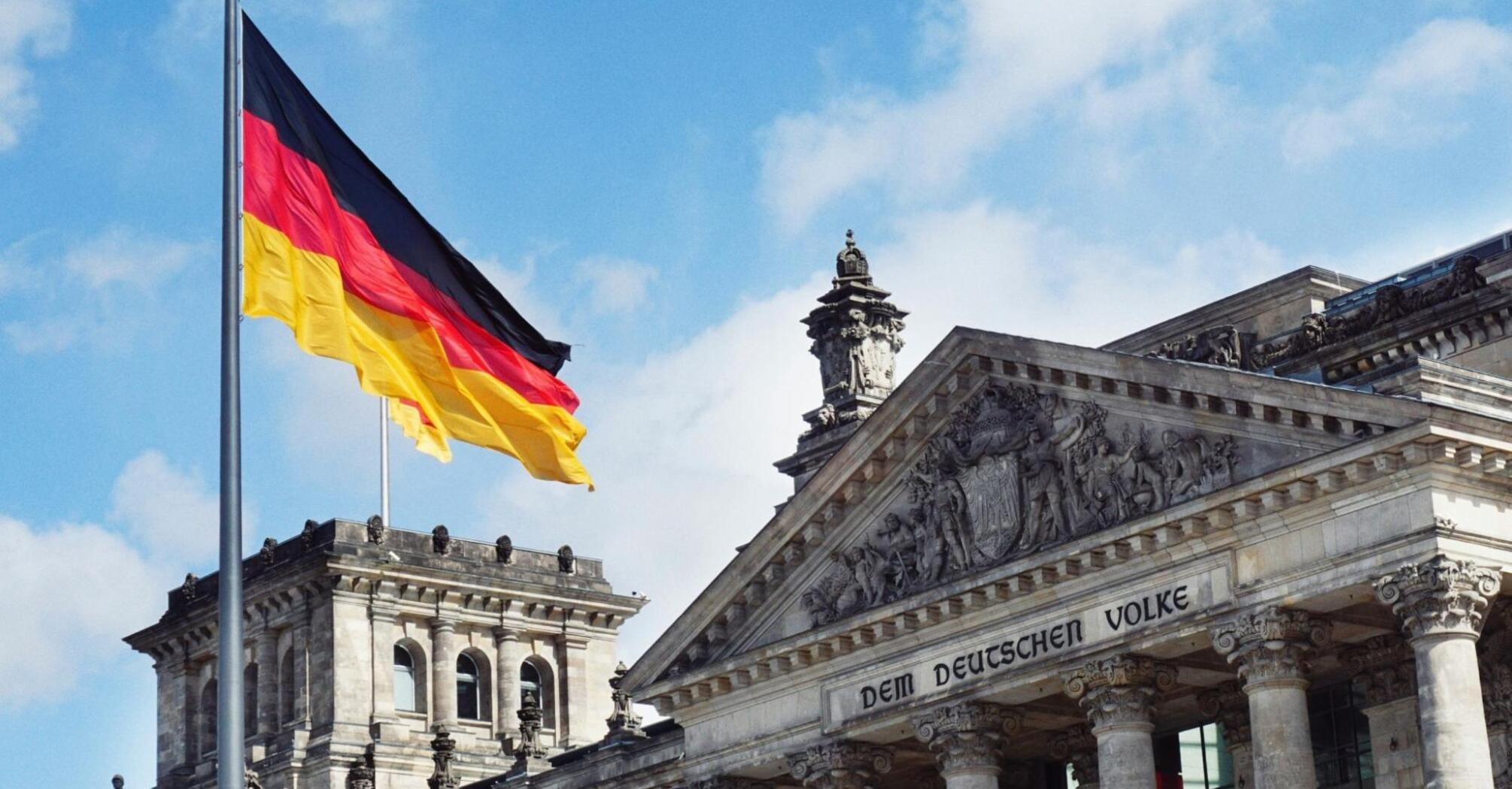 The German flag flies in front of the Reichstag building in Berlin