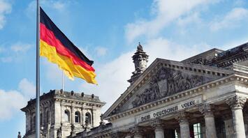 The German flag flies in front of the Reichstag building in Berlin