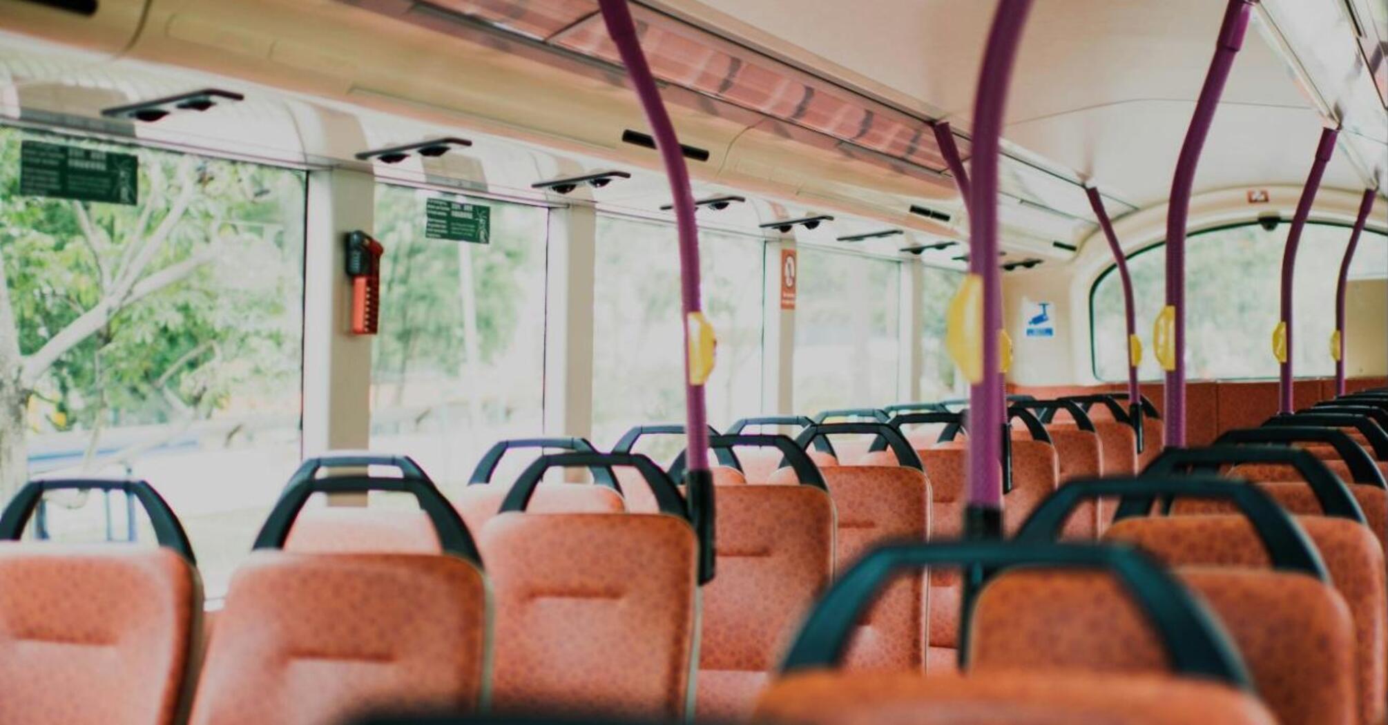 Interior of a public bus with orange seats