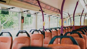 Interior of a public bus with orange seats
