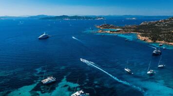 Stunning seaview with the boats on the water on Sardinia Island, Italy