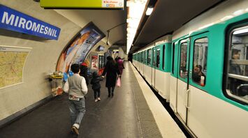 Passengers walking on Miromesnil Metro station platform in Paris