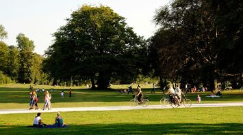 Many people enjoy the afternoon sun on the meadows of the English Garden