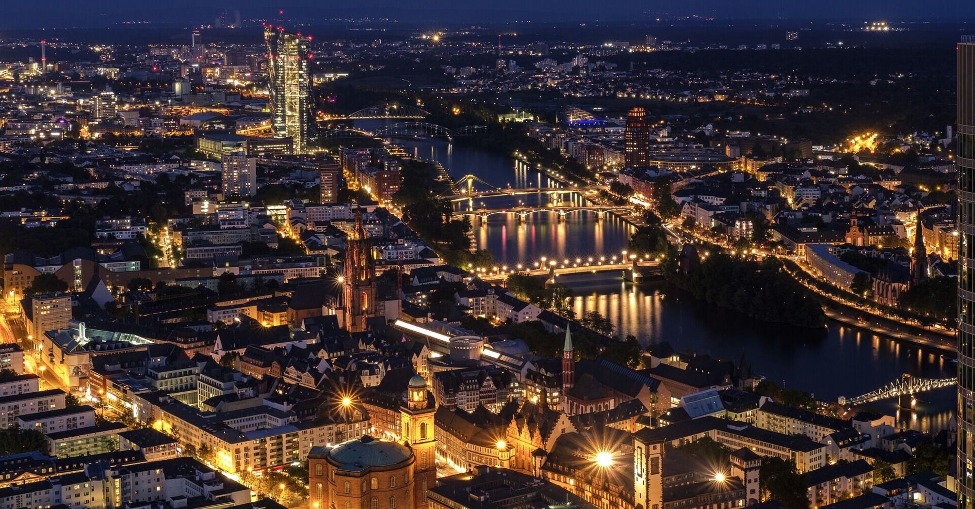 Frankfurt cityscape at night with illuminated bridges and buildings