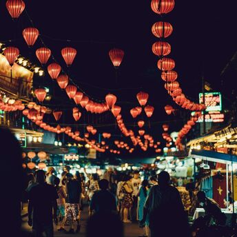 Busy Vietnamese night market adorned with red lanterns