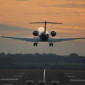 an Lufthansa airplane taking off from an airport runway