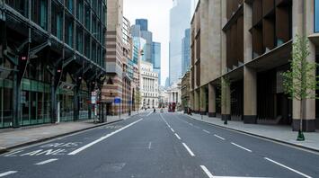 Empty street with bus lane in a city center with modern buildings and a red double-decker bus