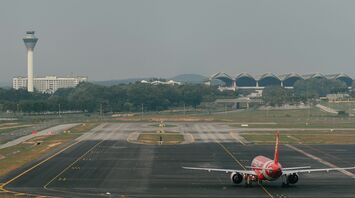AirAsia airplane on the runway at an airport