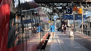 Passengers boarding a train at a railway station