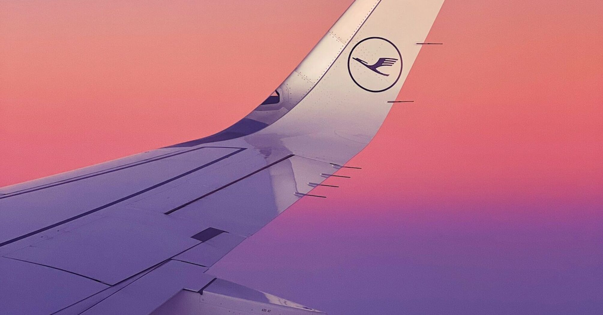 Lufthansa airplane wing during sunset