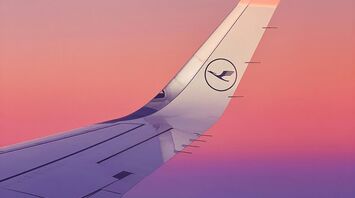 Lufthansa airplane wing during sunset