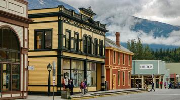 Tourists explore the streets of Juneau, surrounded by