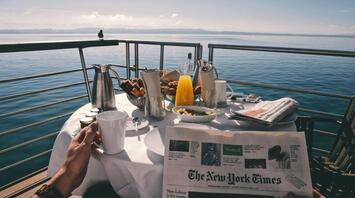 Breakfast with a newspaper on the cruise ship