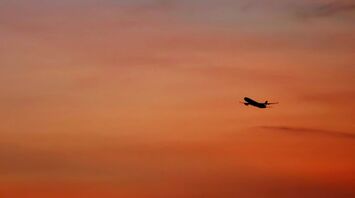 plane in mid air during golden hour