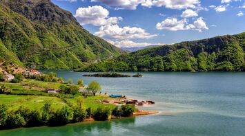 Scenic view of green mountains and a lake in Albania
