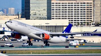 white and blue SAS passenger plane on airport during daytime