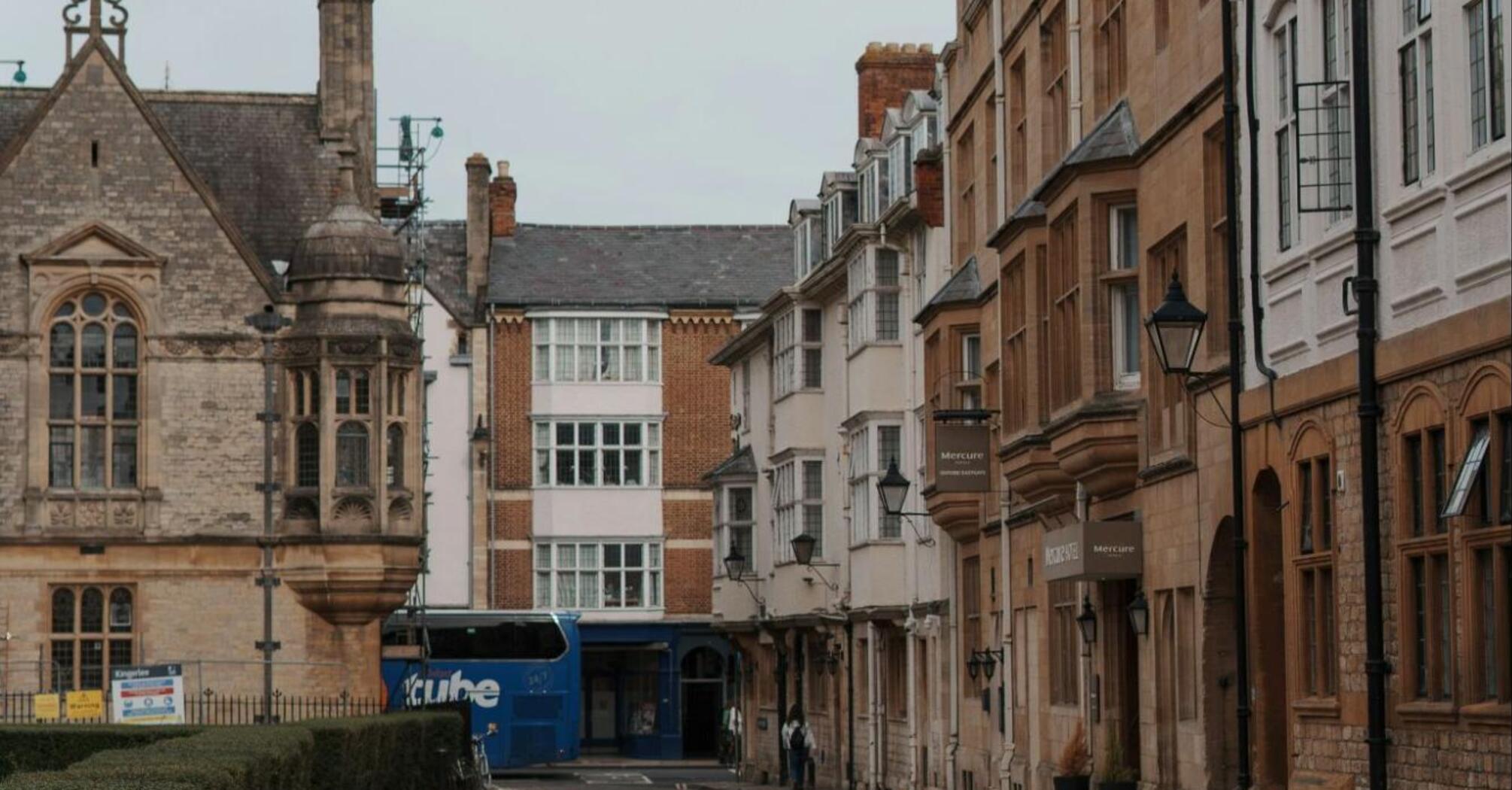 A quiet street with a blue bus in the background
