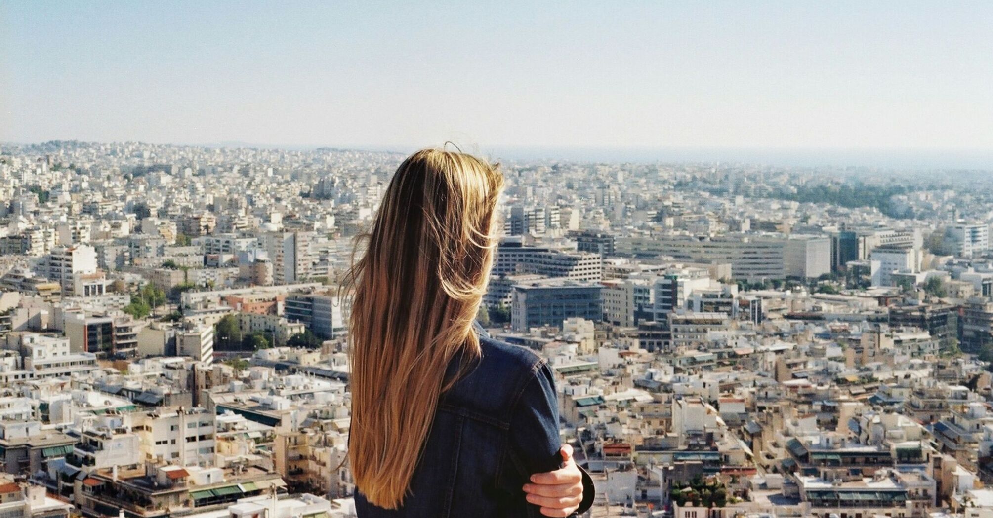 Woman overlooking a sprawling cityscape