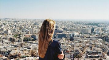 Woman overlooking a sprawling cityscape