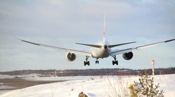 white airplane on white snow field during daytime
