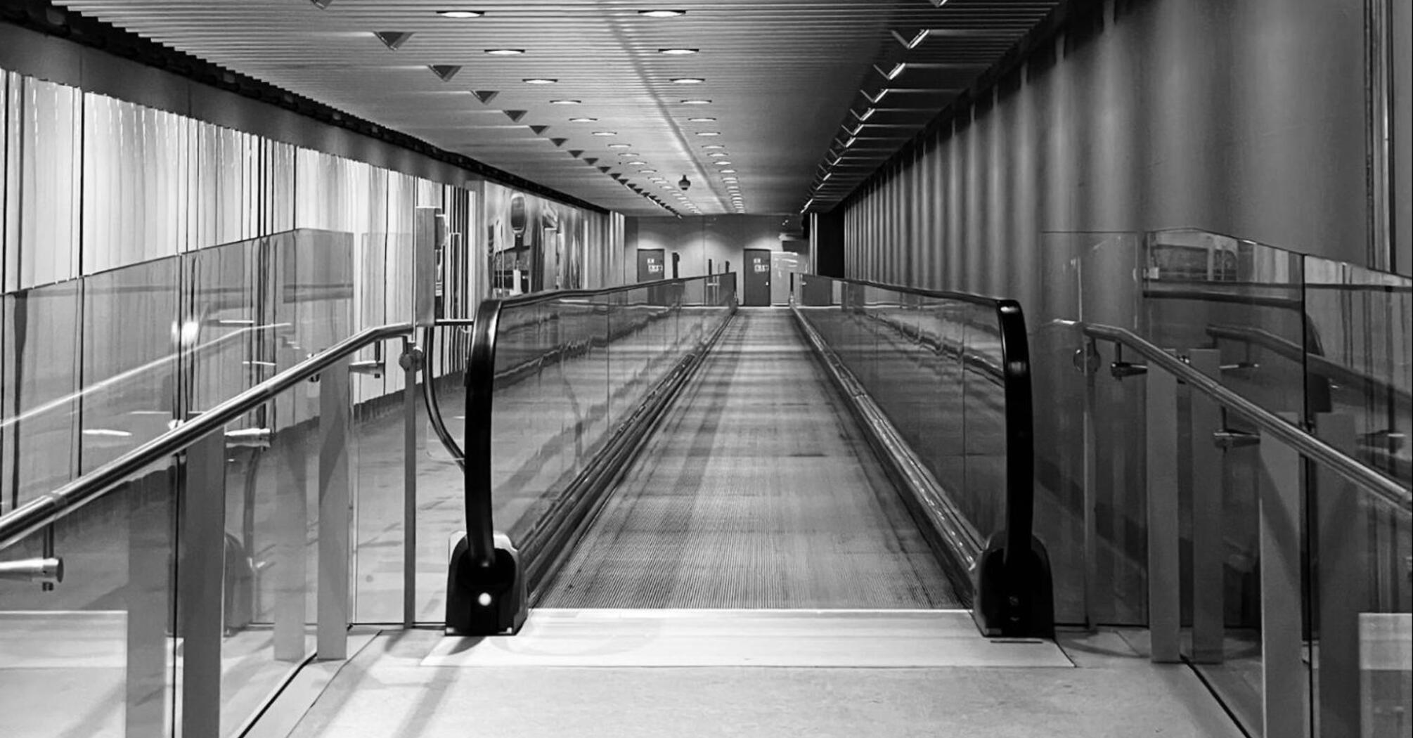 Empty Heathrow airport moving walkway in a modern corridor