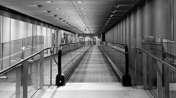 Empty Heathrow airport moving walkway in a modern corridor