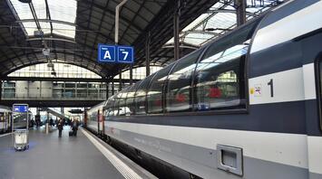 Passengers are waiting for the train on the platform in a modern station