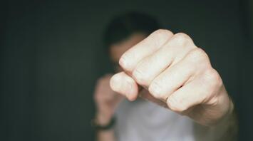 Man showing clenched fist in fighting pose