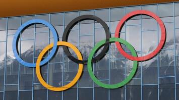 Olympic rings with mountains in the background