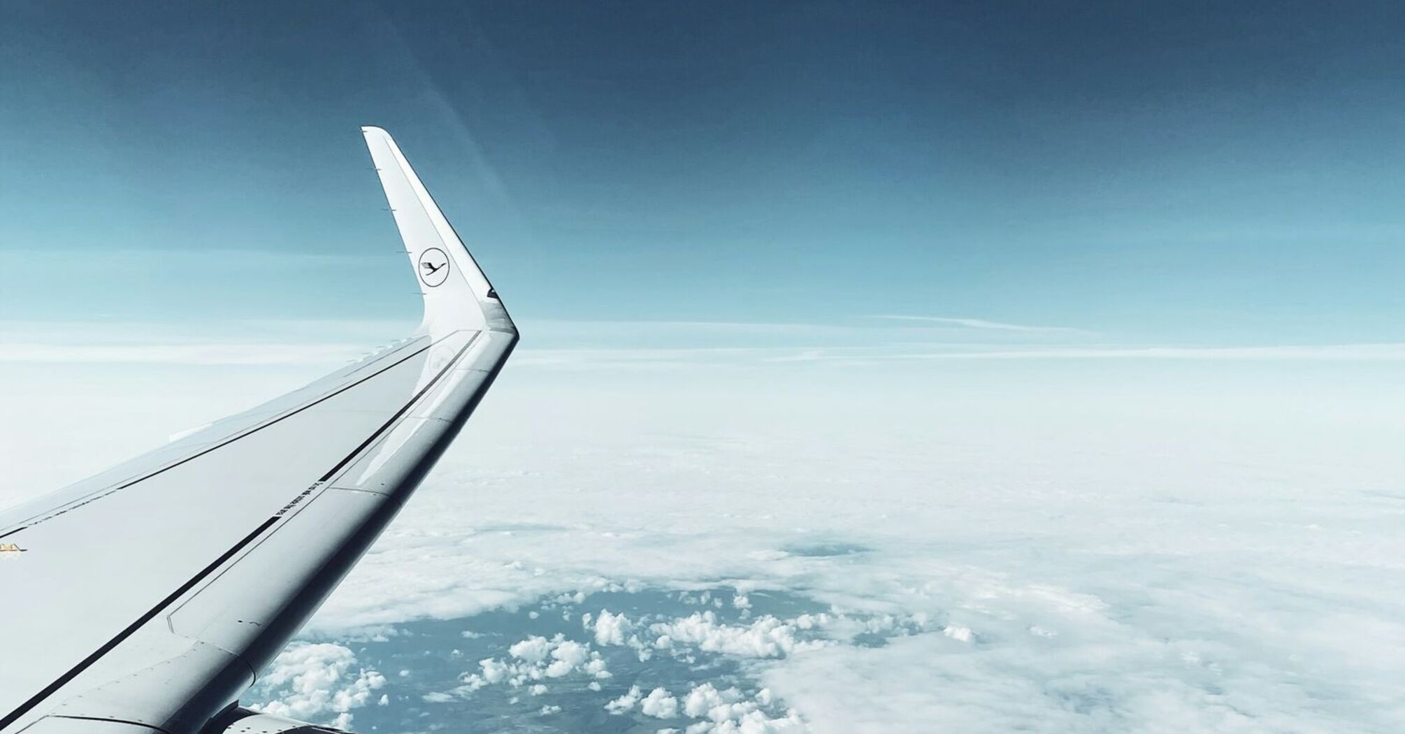 Lufthansa airplane wing and engine in flight