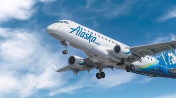 Alaska Airlines plane in flight against a blue sky