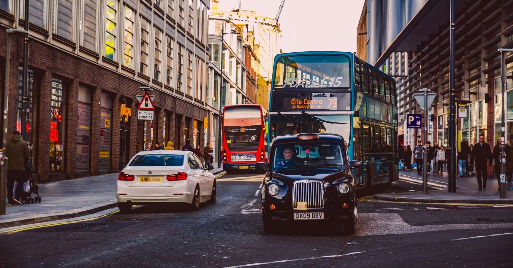 A busy street in Liverpool with buses and cars navigating through the traffic