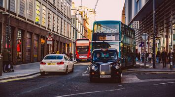 A busy street in Liverpool with buses and cars navigating through the traffic