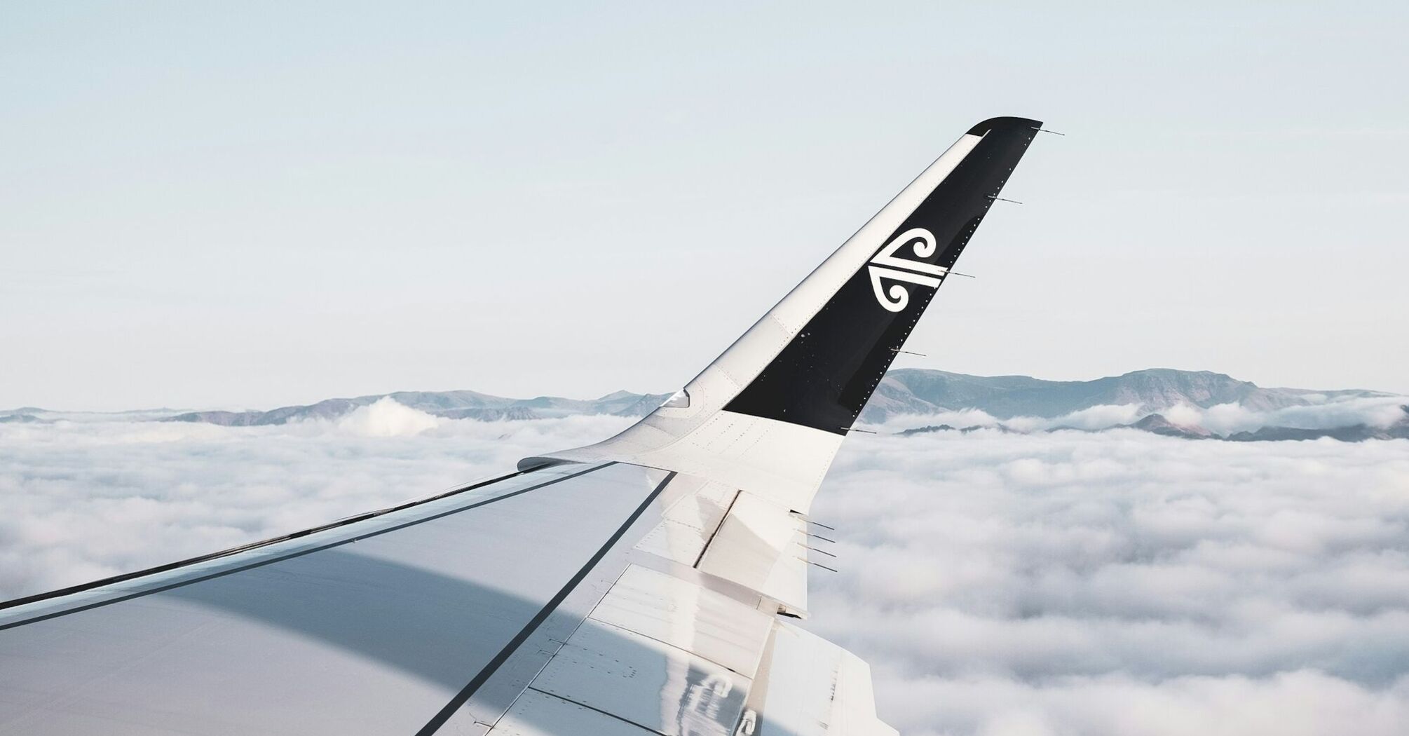 Air New Zealand Dreamliner wing above clouds