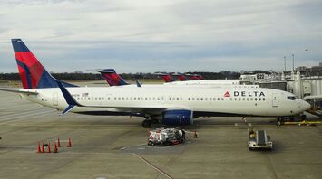 white red and blue delta passenger planes