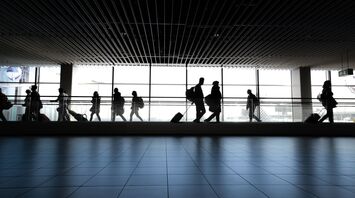Passengers walking through airport terminal