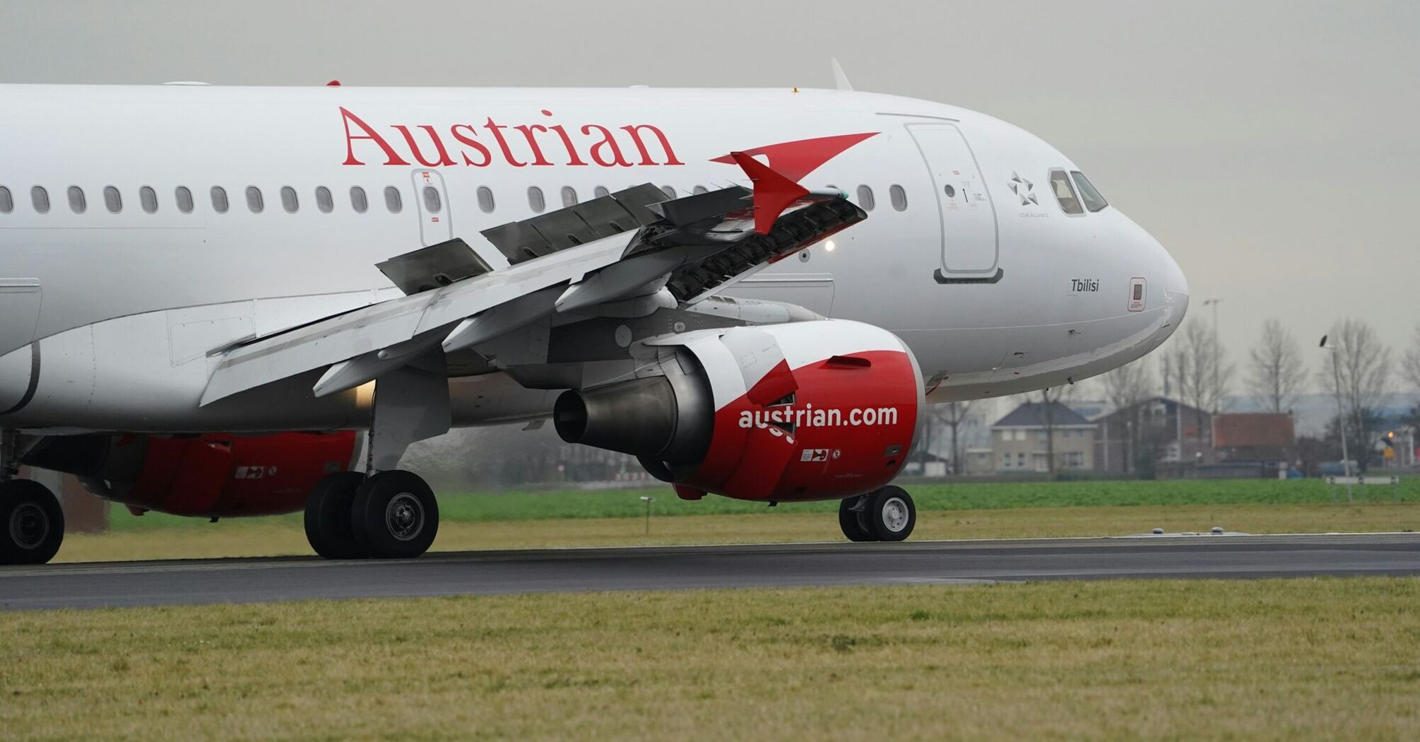 Austrian Airlines airplane taking off from Schiphol's airport runway