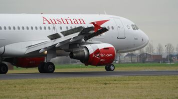 Austrian Airlines airplane taking off from Schiphol's airport runway