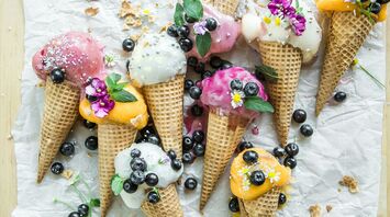 coned ice cream with blueberries and flowers