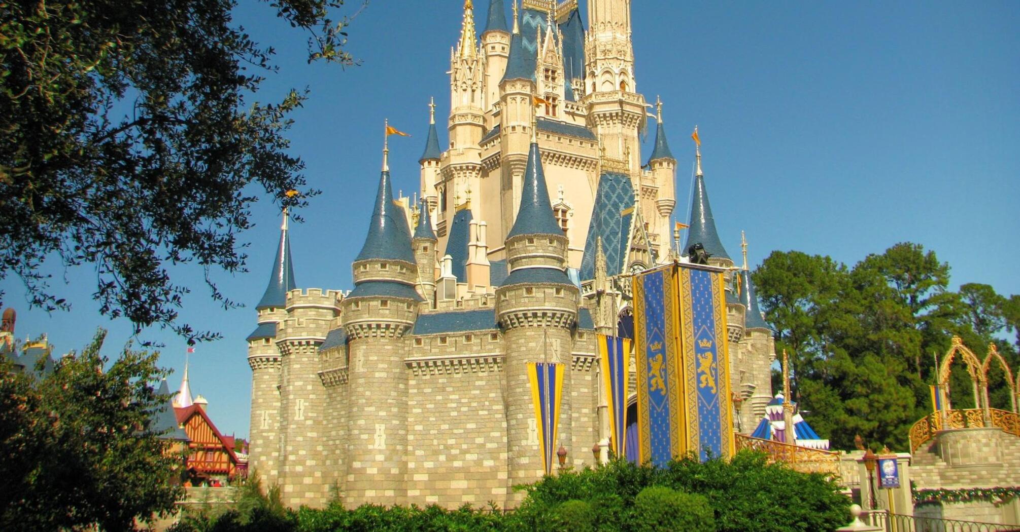 Cinderella Castle at Disneyland, sunny day, trees around