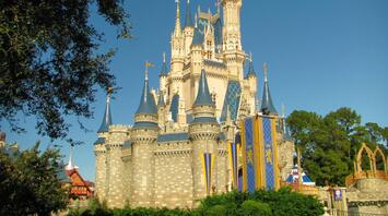 Cinderella Castle at Disneyland, sunny day, trees around