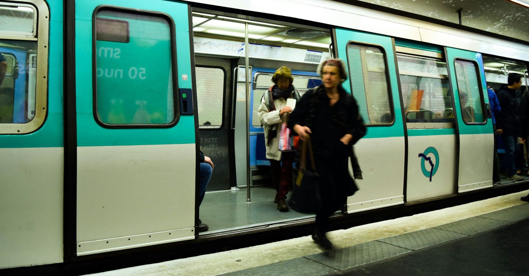 Passengers exiting a metro train in Paris
