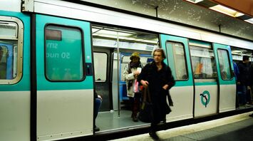 Passengers exiting a metro train in Paris